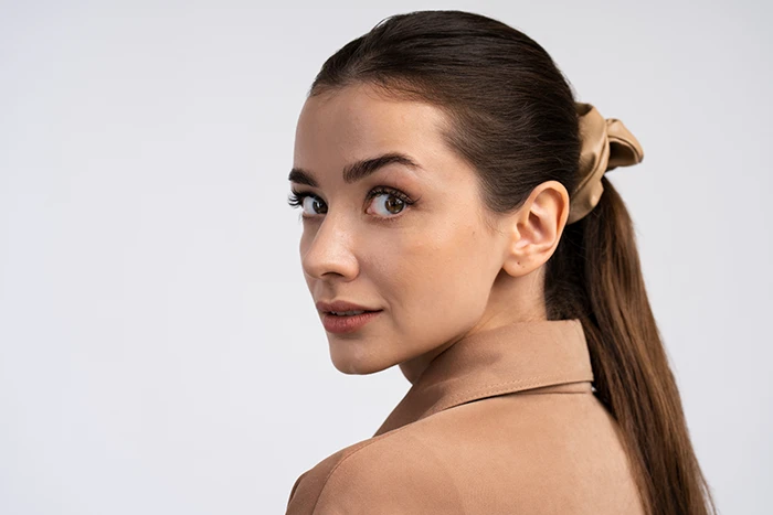 A woman posing with her ear visible