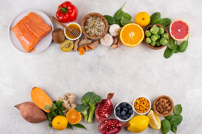 Fruits, vegetables, and proteins on a surface in two separate lines