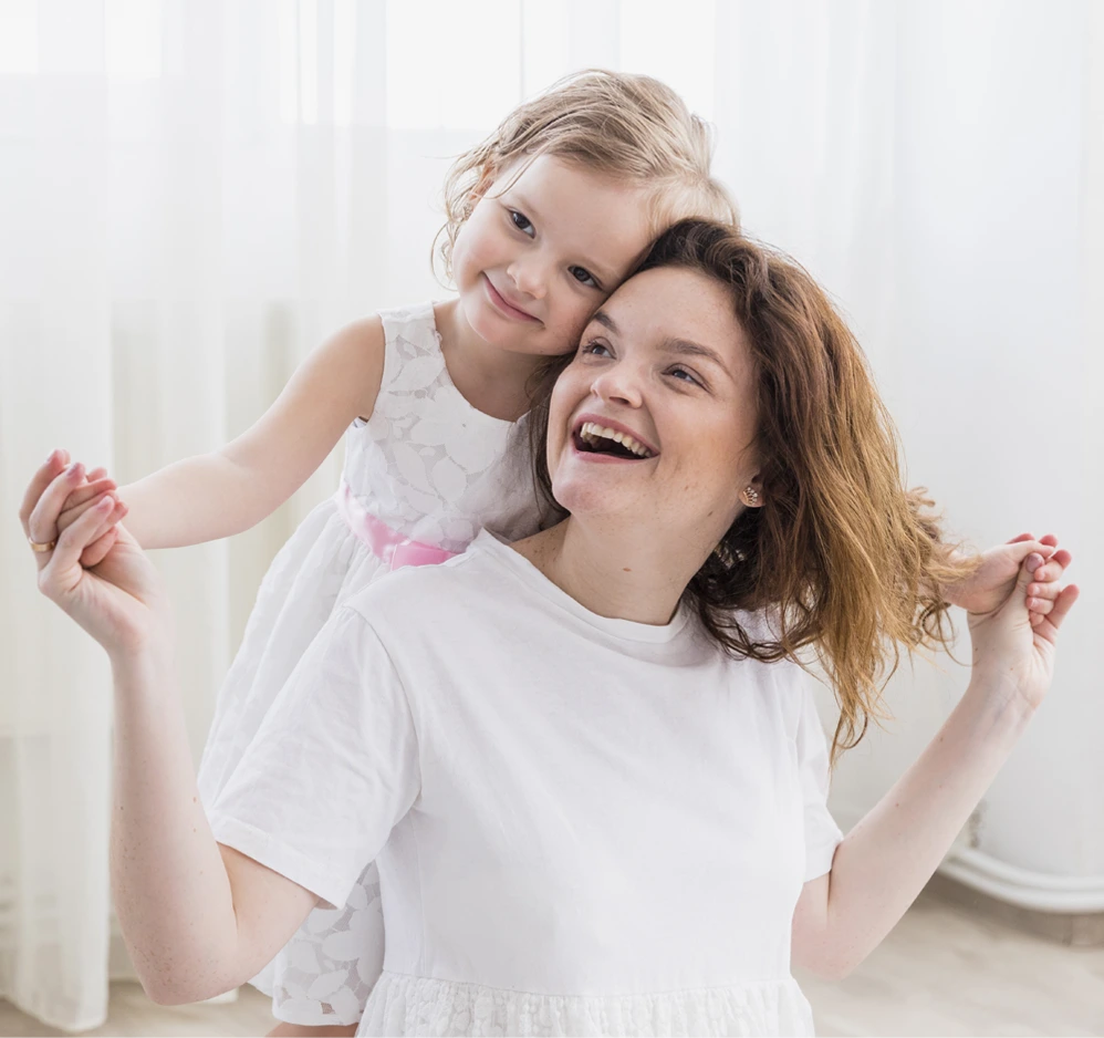 smiling mum playing with her young daughter